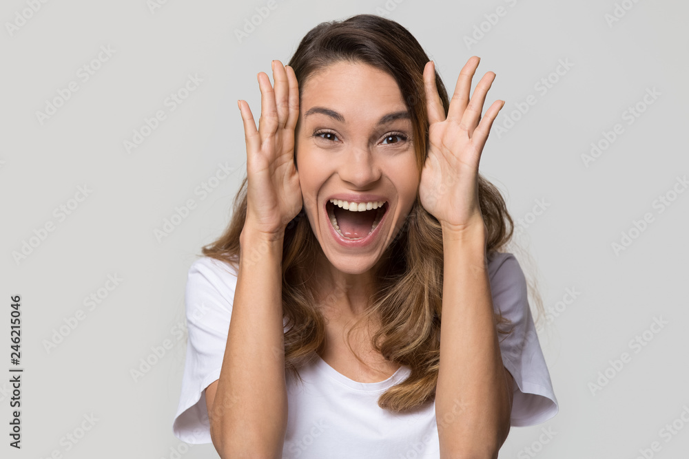 Excited young woman feeling amazed by unbelievable sale looking at camera  screaming with joy isolated on white studio wall, funny euphoric girl  winner on blank light background, head shot portrait Stock Photo |