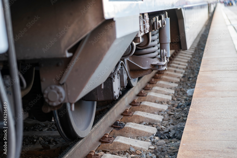 Railway station: a fragment of the lower part of the train with wheels, rails and sleepers. Railway station: a fragment of the lower part of the train with wheels, rails and sleepers.