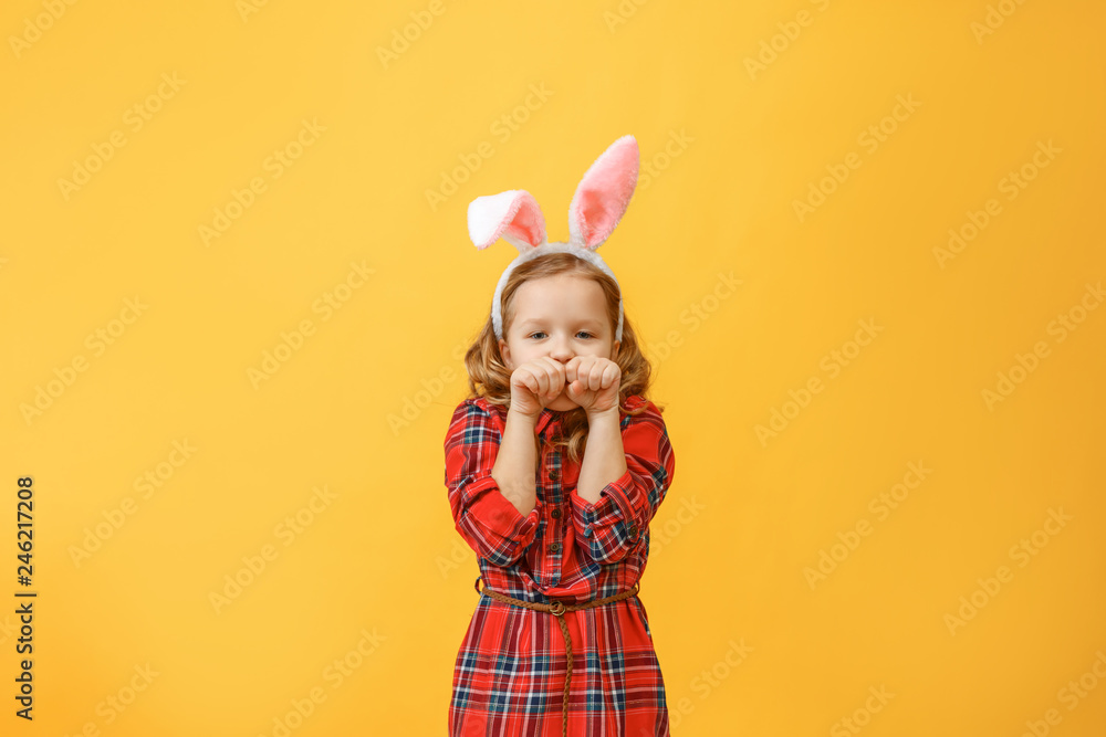 Merry little child girl with bunny ears on a painted background. Happy easter Merry little child girl with bunny ears on a painted background. Happy easter