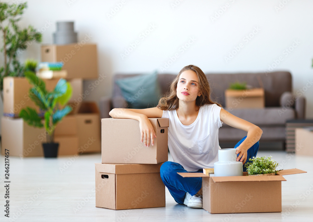 happy girl with boxes moves to new apartment. happy girl with boxes moves to new apartment.