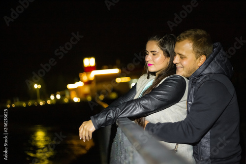 Young love couple in hugs and kisses on faro view , night photo 