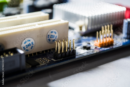 The old motherboard from the computer of blue color. Texture. Spare parts. Repair. Personal computer details. Equipment. 