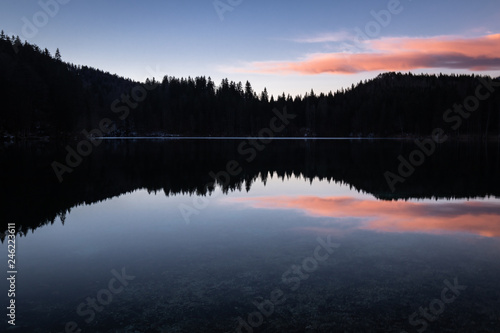 scenic mirror reflection on fusine lakes in sunset  italy