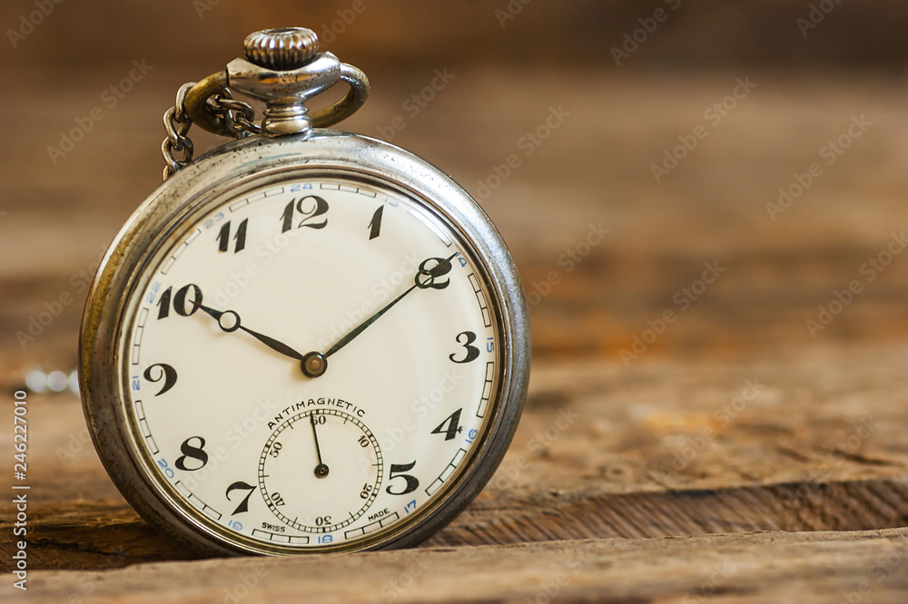 1970 s ancient, old pocket watch and chain, vintage locket watch on chestnut rustic wooden background. Antique concept 1970 s ancient, old pocket watch and chain, vintage locket watch on chestnut rustic wooden background. Antique concept