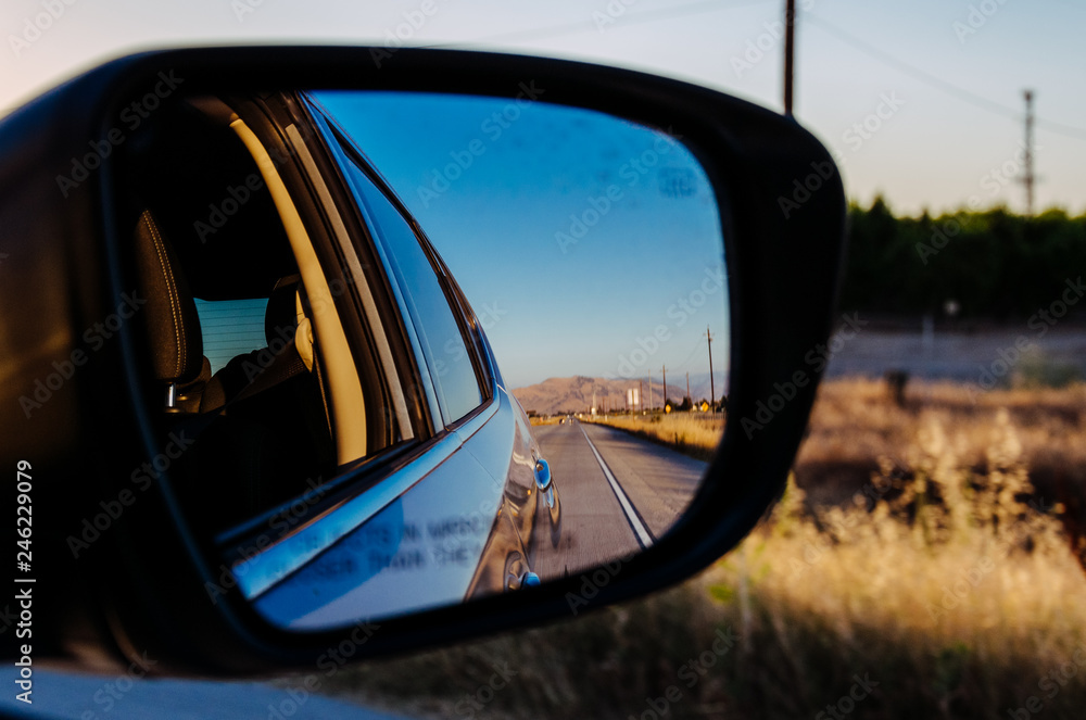 Traveling in California by car. View in the side mirror