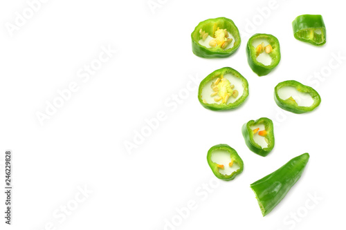 sliced green hot chili peppers isolated on white background top view