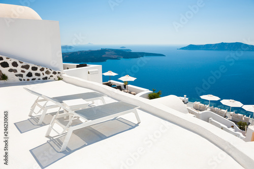 Two chaise lounges on the terrace with sea view. Santorini island, Greece © smallredgirl