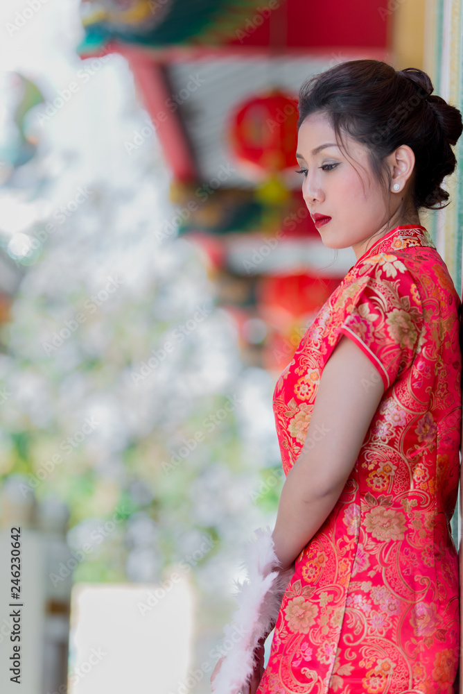 Portrait of beautiful asian woman in Cheongsam dress,Thailand people,Happy Chinese new year concept Portrait of beautiful asian woman in Cheongsam dress,Thailand people,Happy Chinese new year concept