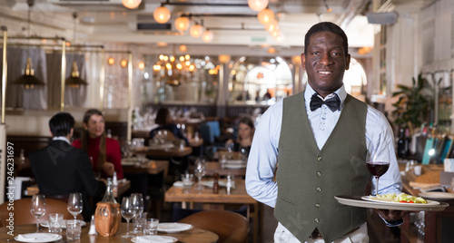 African American waiter with serving tray