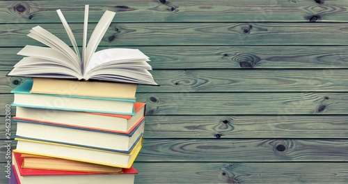 Stack of books on wooden background