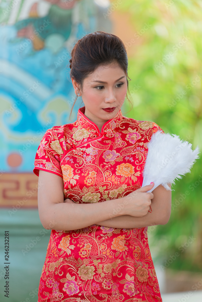 Portrait of beautiful asian woman in Cheongsam dress,Thailand people,Happy Chinese new year concept Portrait of beautiful asian woman in Cheongsam dress,Thailand people,Happy Chinese new year concept
