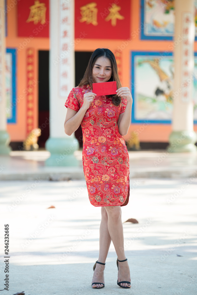 Portrait of beautiful asian woman in Cheongsam dress,Thailand people,Happy Chinese new year concept Portrait of beautiful asian woman in Cheongsam dress,Thailand people,Happy Chinese new year concept