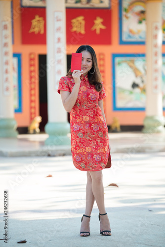 Portrait of beautiful asian woman in Cheongsam dress,Thailand people,Happy Chinese new year concept © reewungjunerr