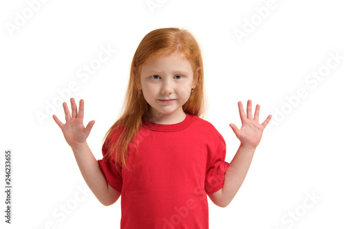 Little girl smiling with his arms up. 5 years old girl surprised with smile and hands near her hands