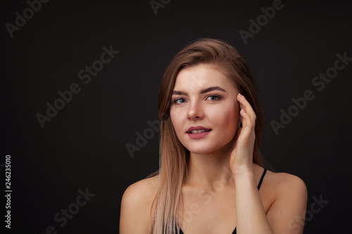 Young beautiful woman against dark background