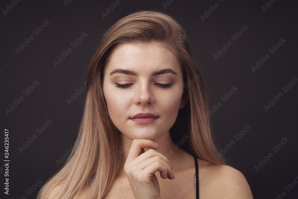 Young beautiful woman against dark background Young beautiful woman against dark background