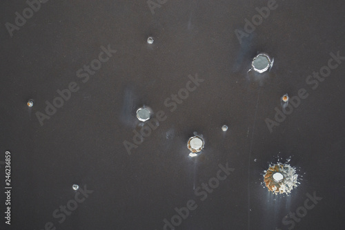 Armor shot through with bullets. Bullet holes