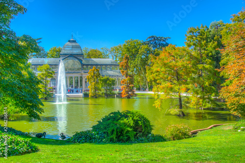 Fountain in a pond in front of the crystal palace at the Parque del Buen Retiro in Madrid, Spain