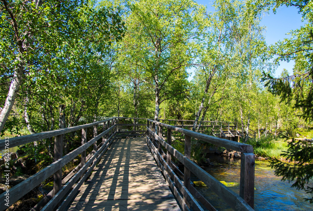 Wooden bridge and summer view, Äkäsmylly, Muonio, Lapland, Finland Wooden bridge and summer view, Äkäsmylly, Muonio, Lapland, Finland