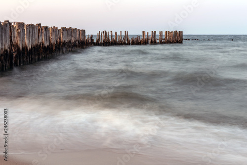 Wooden breakwaters on the sea shore