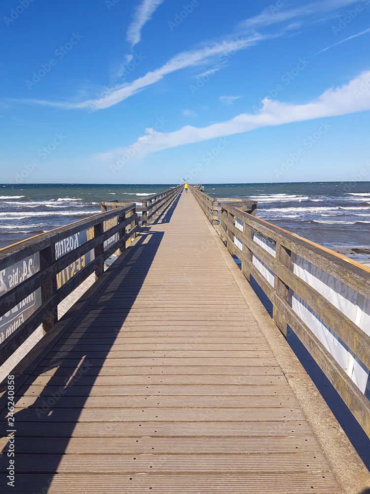 Traditional wooded sea bridge pier with nobody against baltic sea