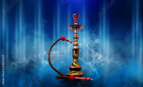 Hookah smoking on a blue futuristic background of an empty room, neon light, smoke