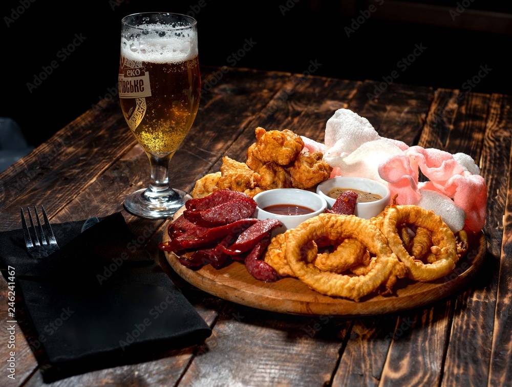 Beer plate with chips, sausage, fried onion and sauce. Beer plate with chips, sausage, fried onion and sauce.