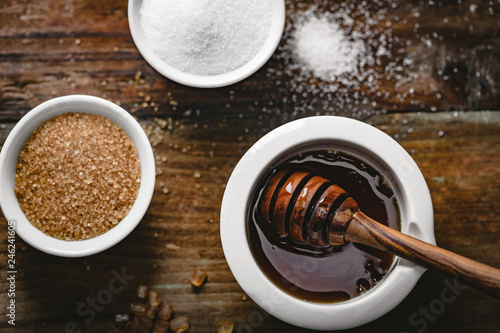 different kinds of sugar and maple syrup on a background