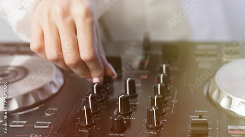 Close-up of a girl's hand that plays on professional DJ equipment
