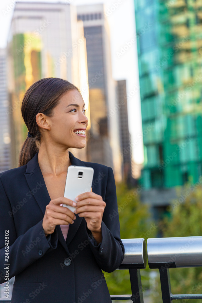Mobile phone Asian business woman in suit outside working on cellphone texting .Realtor or real estate agent lifestyle. Chinese elegant lady outdoor happy. Businesswoman at work. Mobile phone Asian business woman in suit outside working on cellphone texting .Realtor or real estate agent lifestyle. Chinese elegant lady outdoor happy. Businesswoman at work.