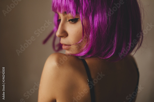 Beautiful back of naked woman wear pink wig. Portrait of nude girl. Sexy young lady in black underwear. Hot woman wear lingerie.