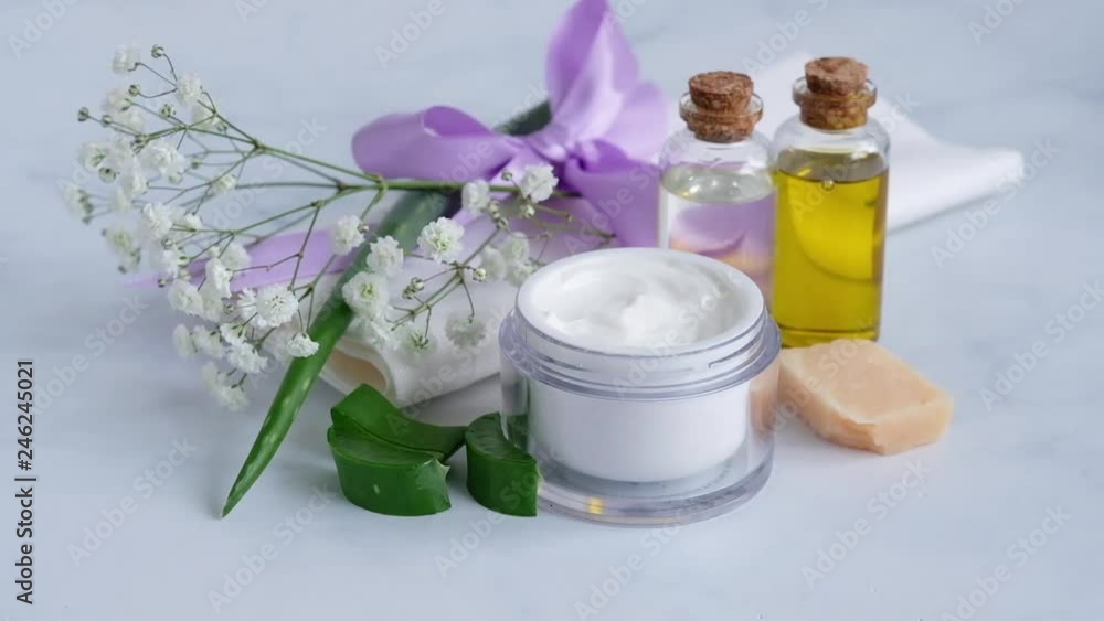 womans hand taking the cream with aloe vera from the jar with index finger womans hand taking the cream with aloe vera from the jar with index finger