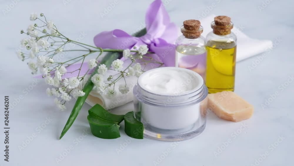 womans hand taking the cream with aloe vera from the jar with index finger womans hand taking the cream with aloe vera from the jar with index finger