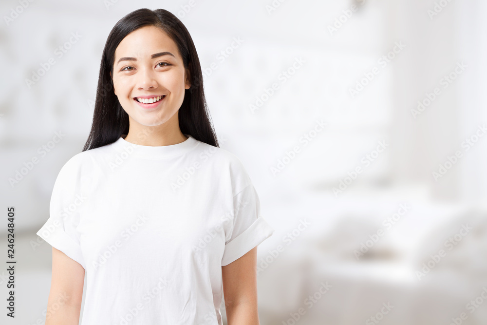 Smiling young asian woman with perfect skin care and template t shirt at home background. Blank t shirt and summer concept. Copy space Smiling young asian woman with perfect skin care and template t shirt at home background. Blank t shirt and summer concept. Copy space