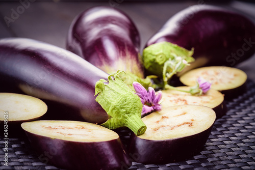 Dietary healthy food. Low-calorie product of healthy diet. Fresh sliced eggplant. Eggplant close up. Slices of eggplant with greens. Eggplant bloom..Healthy eating concept.