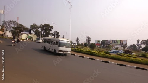 Traffic circle, roundabout with cars, motorbikes, motorcycles, bus, buses driving on a road in Kigali, Rwanda  photo