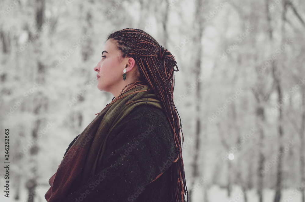 stylish portrait of an attractive woman with long pigtails, dressed in an eco-coat and scarf, walked in a winter-frozen city stylish portrait of an attractive woman with long pigtails, dressed in an eco-coat and scarf, walked in a winter-frozen city