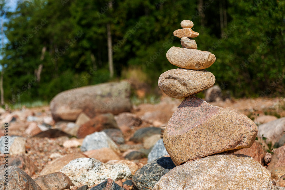 Zen pyramid of stones on seashore.Concept harmony and balance,spa and yoga Zen pyramid of stones on seashore.Concept harmony and balance,spa and yoga