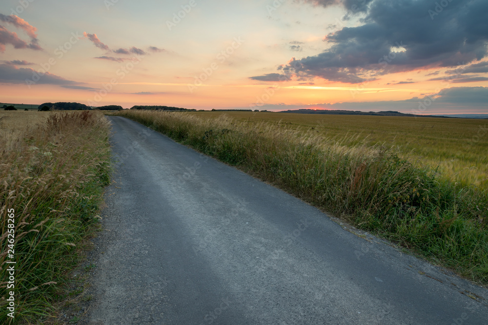 Road to nowhere in country lane at sunset