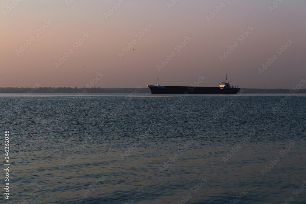 big ship at sea at sunset