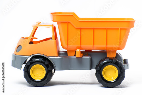 Photography Plastic toy yellow truck on a white background. Close-up.