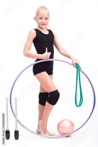 Teenager girl holding rhythmic gymnastics accessories