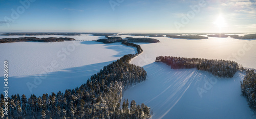 Aerial winter landscape panorama of ridge road in Punkaharju, Finland.