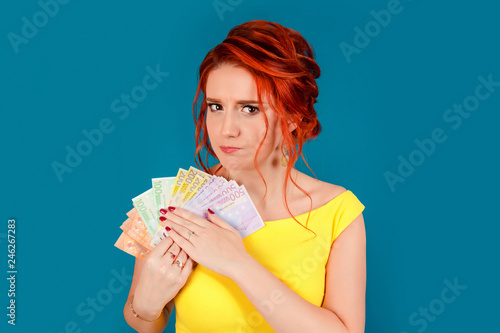 greedy young woman, holding tight euro banknotes