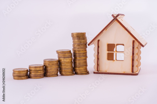 Financial real estate, gold coins and house. Concept: Property investment and house mortgage financial 