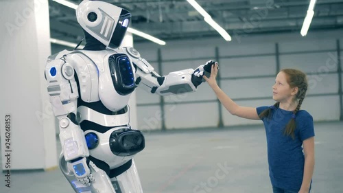 Cybrog is giving a high-five to a little girl photo