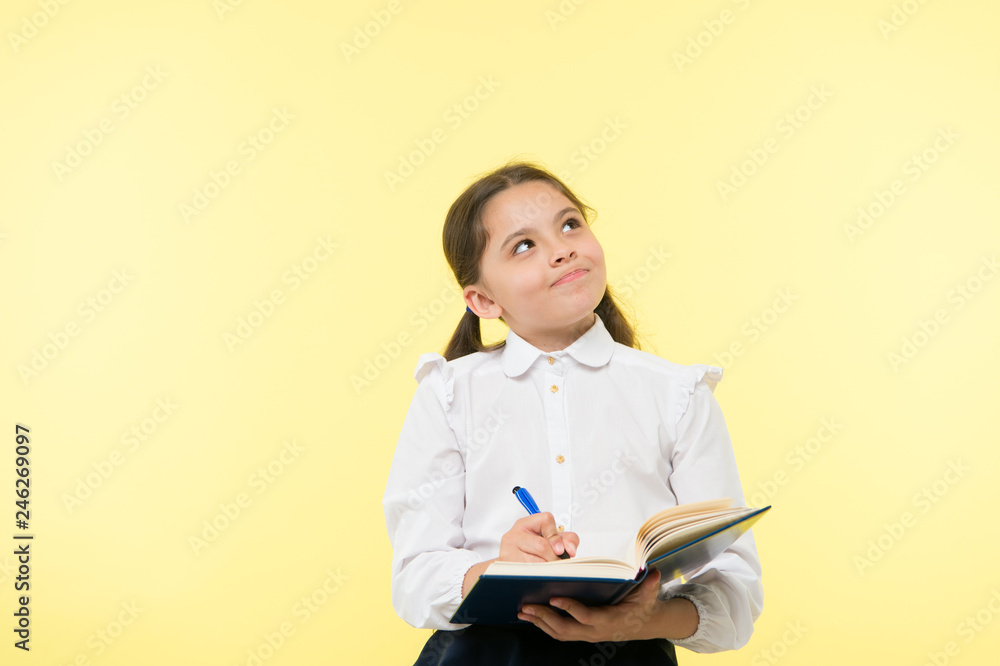 Child school uniform kid doing homework. Child girl school uniform clothes hold book and pen. Girl cute write down idea notes. Notes to remember. Write essay or notes. Personal schedule. Making notes Child school uniform kid doing homework. Child girl school uniform clothes hold book and pen. Girl cute write down idea notes. Notes to remember. Write essay or notes. Personal schedule. Making notes