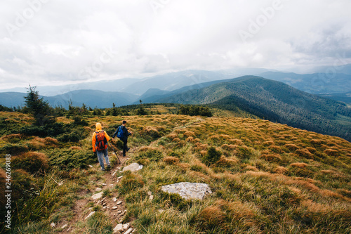 Two persons wandering in the woods and the mountains 
