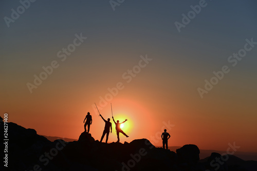 team of four people climbers and peak success in sunrise time