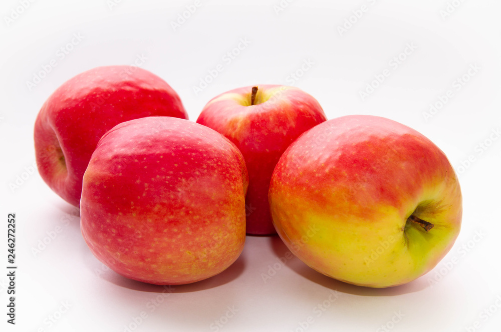 four red-yellow apples on a white background four red-yellow apples on a white background